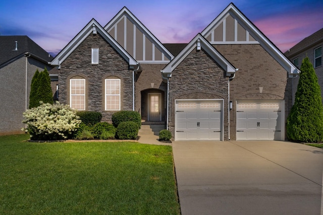 2030 Oliver Dr, Mount Juliet, TN 37122 - view of front facade with concrete driveway, stone siding, a lawn, an attached garage, and board and batten siding