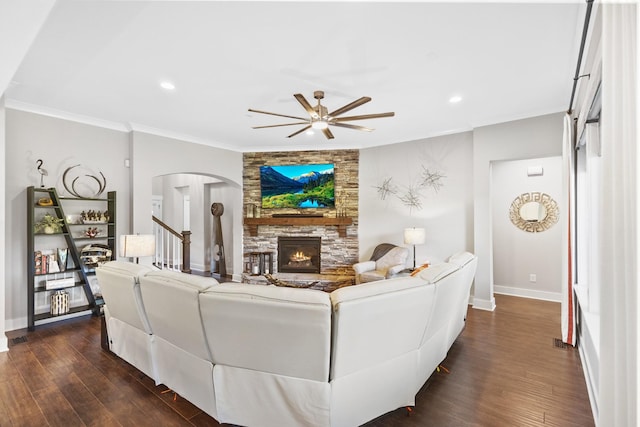 2030 Oliver Dr, Mount Juliet, TN 37122 - living room featuring ceiling fan, arched walkways, a fireplace, crown molding, and dark wood-type flooring