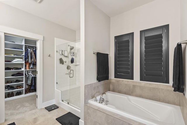 2030 Oliver Dr, Mount Juliet, TN 37122 - bathroom featuring a garden tub, a spacious closet, a shower stall, and tile patterned flooring