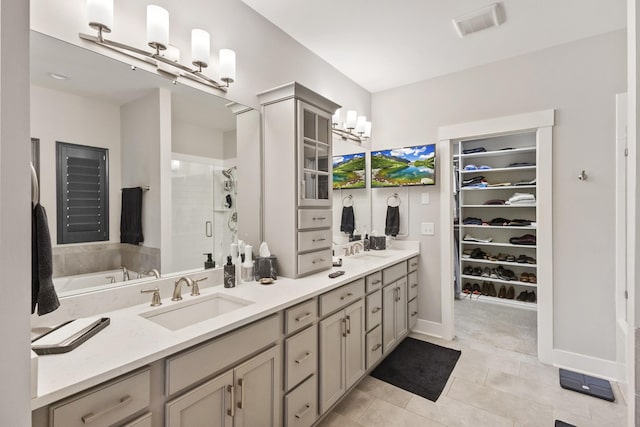 2030 Oliver Dr, Mount Juliet, TN 37122 - bathroom with a shower stall, double vanity, a walk in closet, tile patterned flooring, and a garden tub