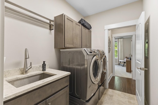 2030 Oliver Dr, Mount Juliet, TN 37122 - laundry room featuring independent washer and dryer, cabinet space, and dark wood-style floors