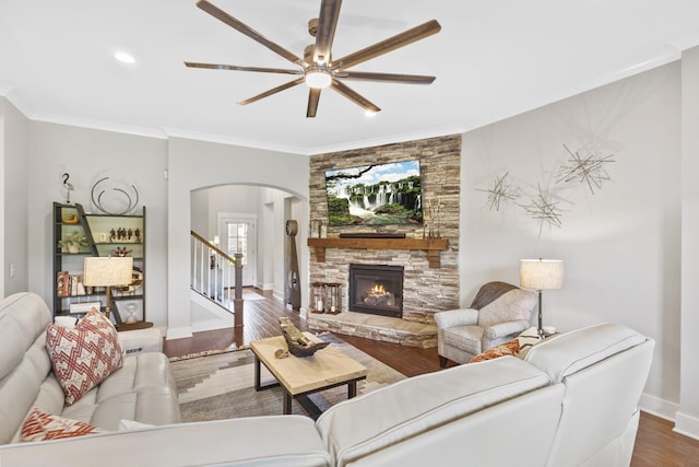 2030 Oliver Dr, Mount Juliet, TN 37122 - living area featuring arched walkways, a ceiling fan, wood finished floors, a fireplace, and crown molding