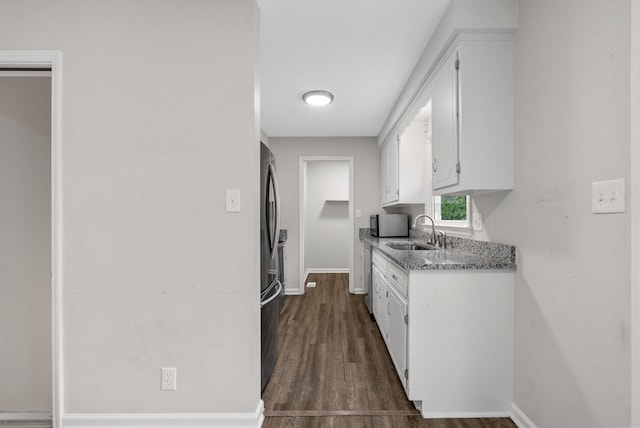 712 Green Valley Ct, Clarksville, TN 37042 - kitchen featuring white cabinetry, dark wood-style floors, freestanding refrigerator, and light stone countertops