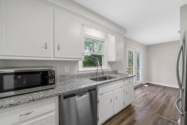 712 Green Valley Ct, Clarksville, TN 37042 - kitchen with appliances with stainless steel finishes, dark wood-type flooring, white cabinets, and light stone counters