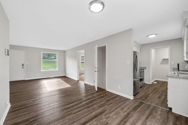 712 Green Valley Ct, Clarksville, TN 37042 - unfurnished living room with dark wood-style floors and baseboards