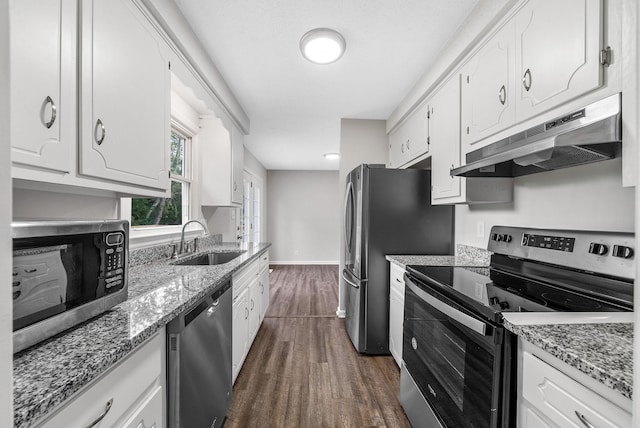 712 Green Valley Ct, Clarksville, TN 37042 - kitchen with stainless steel appliances, under cabinet range hood, dark wood-style flooring, white cabinets, and light stone countertops
