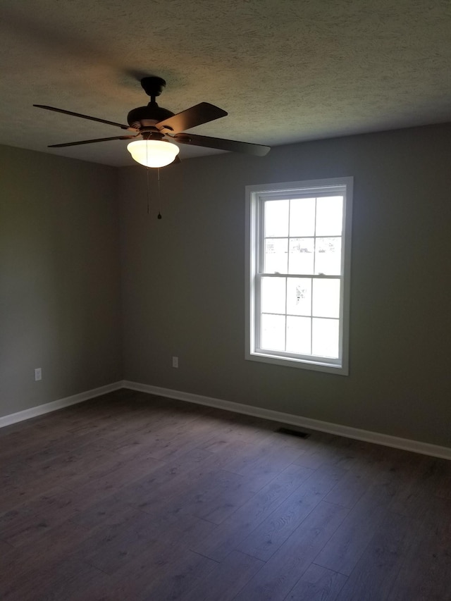 3101 Galen Rd, Lafayette, TN 37083 - spare room with dark wood finished floors, ceiling fan, and a textured ceiling