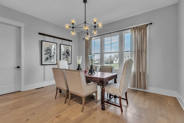 2113 Southern Preserve Ln, Franklin, TN 37064 - dining area with a chandelier and light wood-style flooring