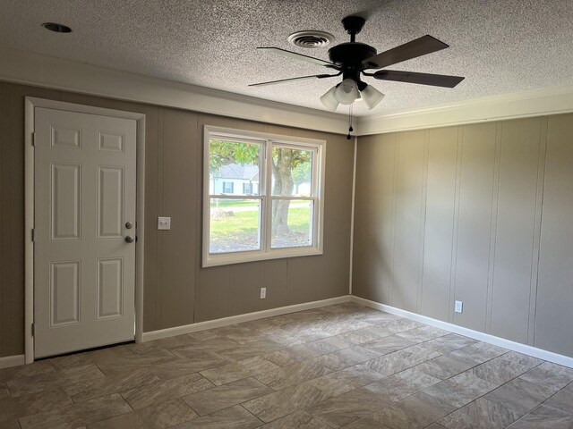 208 Skyline Dr, Red Boiling Springs, TN 37150 - spare room featuring a textured ceiling, ceiling fan, a decorative wall, and crown molding