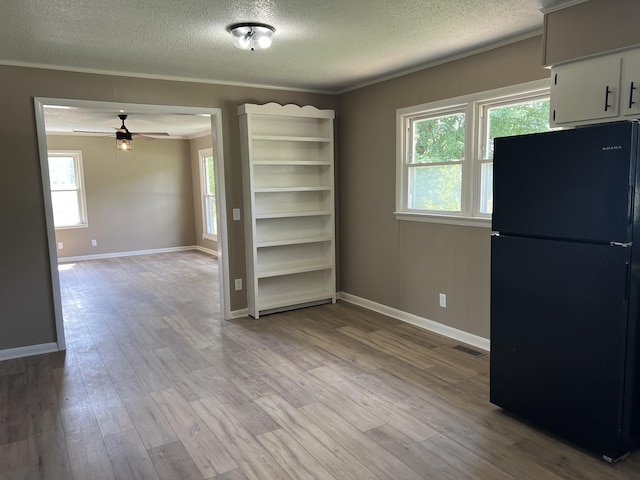 208 Skyline Dr, Red Boiling Springs, TN 37150 - unfurnished dining area featuring a textured ceiling, ceiling fan, light wood-type flooring, and ornamental molding