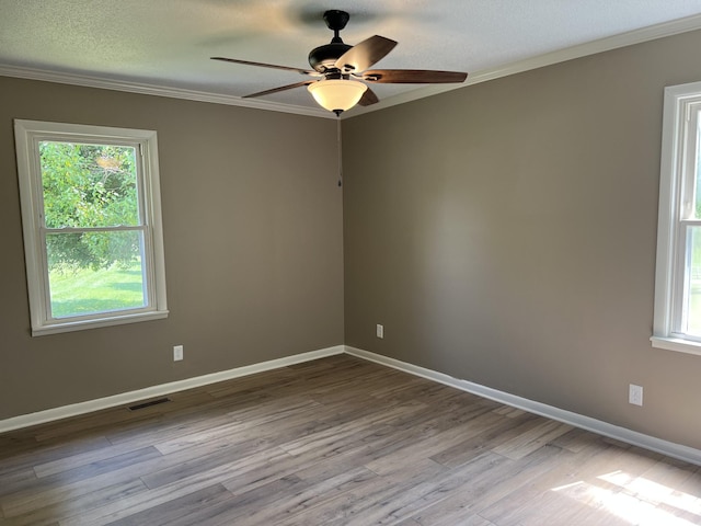 208 Skyline Dr, Red Boiling Springs, TN 37150 - spare room featuring crown molding, a ceiling fan, healthy amount of natural light, wood finished floors, and a textured ceiling