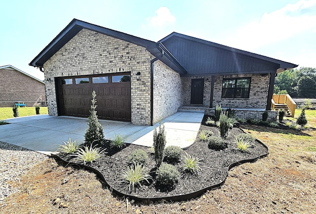 226 Elmwood Dr, Rock Island, TN 38581 - view of front of home with a garage, concrete driveway, and brick siding