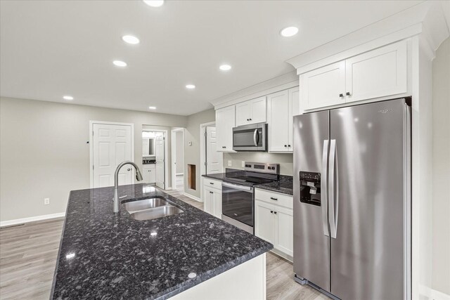 226 Elmwood Dr, Rock Island, TN 38581 - kitchen featuring appliances with stainless steel finishes, light wood-type flooring, white cabinetry, a center island with sink, and recessed lighting