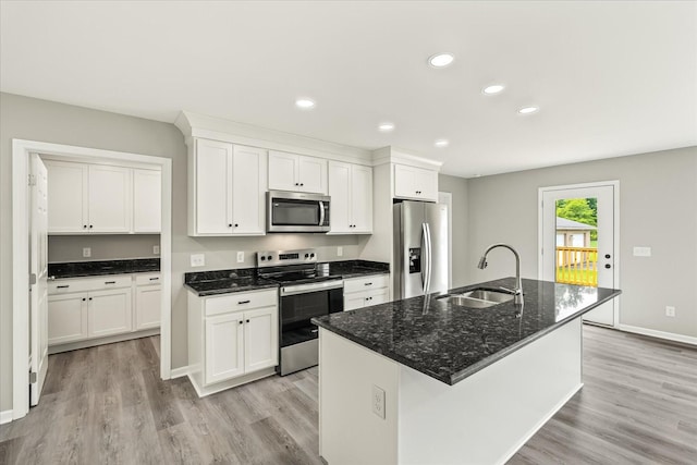 226 Elmwood Dr, Rock Island, TN 38581 - kitchen with appliances with stainless steel finishes, light wood-style flooring, white cabinetry, recessed lighting, and a kitchen island with sink