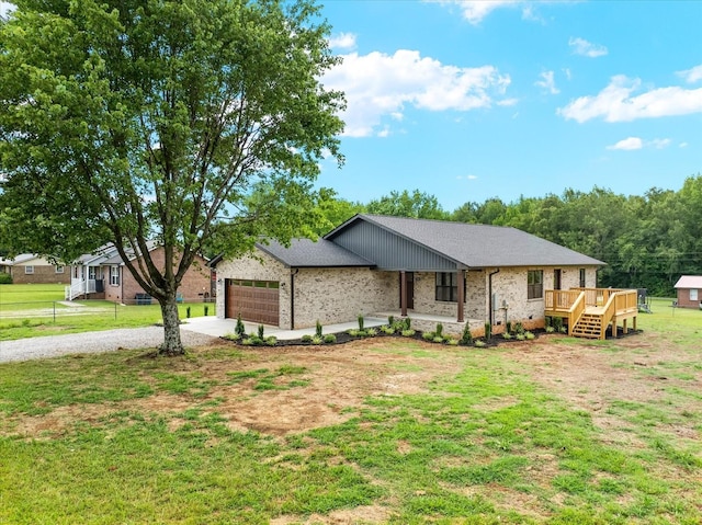 226 Elmwood Dr, Rock Island, TN 38581 - single story home with concrete driveway, an attached garage, a front yard, brick siding, and a deck