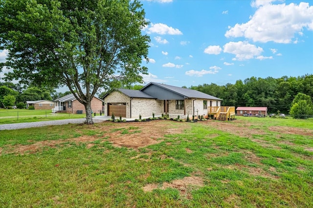 226 Elmwood Dr, Rock Island, TN 38581 - view of front of property with a garage, driveway, brick siding, and a wooden deck