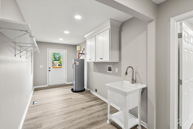 226 Elmwood Dr, Rock Island, TN 38581 - laundry room with hookup for a washing machine, water heater, hookup for an electric dryer, recessed lighting, and light wood-style floors