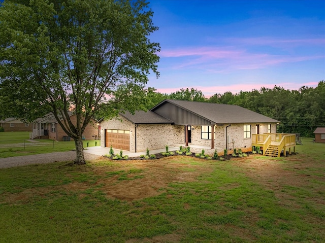 226 Elmwood Dr, Rock Island, TN 38581 - ranch-style home featuring concrete driveway, an attached garage, a lawn, a deck, and brick siding