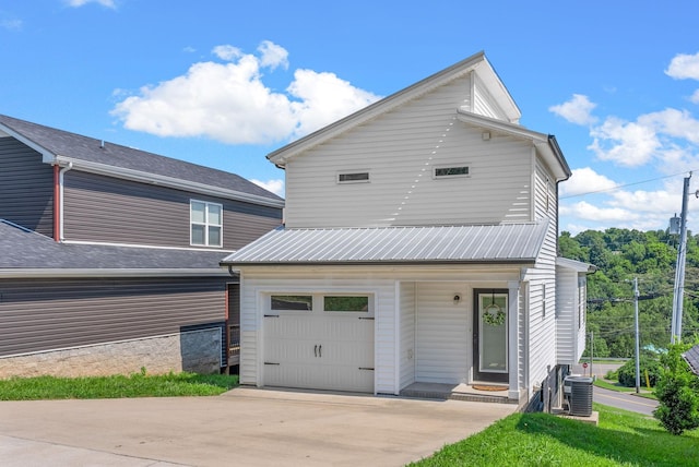 76 W High St, Clarksville, TN 37040 - view of front of property featuring driveway, an attached garage, and a metal roof