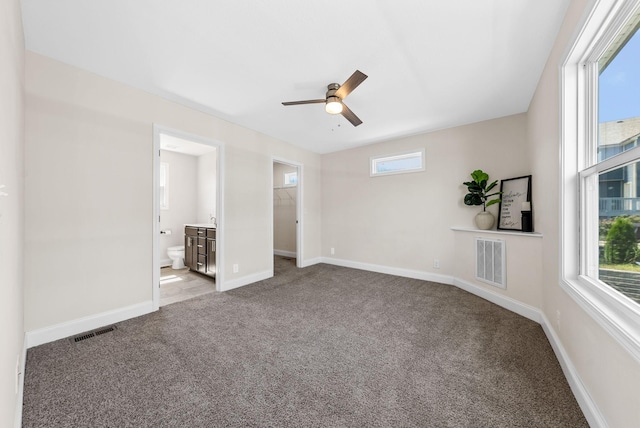 76 W High St, Clarksville, TN 37040 - unfurnished bedroom featuring carpet flooring, connected bathroom, a spacious closet, and a ceiling fan