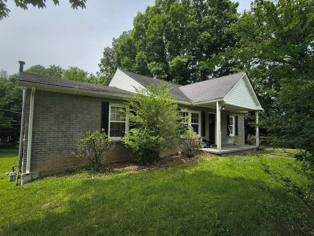261 Caldwell Ln, Clarksville, TN 37040 - view of side of home featuring a lawn, a porch, and brick siding