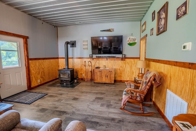 357 Providence Rd, Pulaski, TN 38478 - living room featuring wooden walls, wainscoting, a wood stove, and wood finished floors