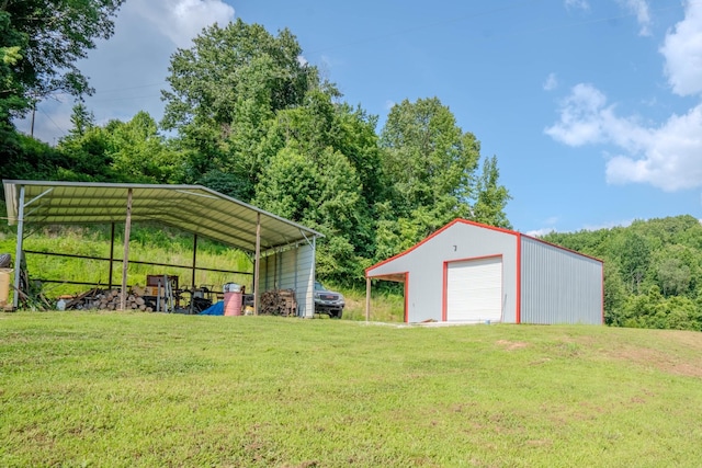 357 Providence Rd, Pulaski, TN 38478 - view of green lawn featuring an outdoor structure, a garage, driveway, and a carport