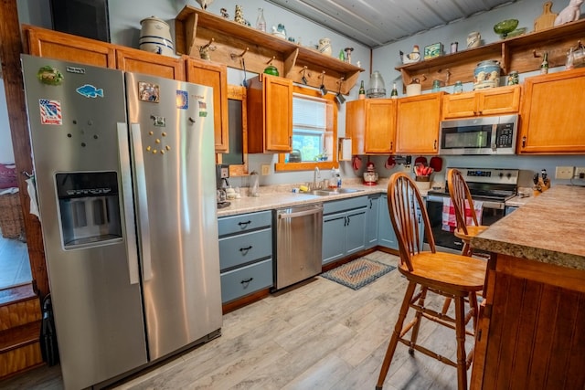 357 Providence Rd, Pulaski, TN 38478 - kitchen with appliances with stainless steel finishes, light wood-style flooring, open shelves, and light countertops