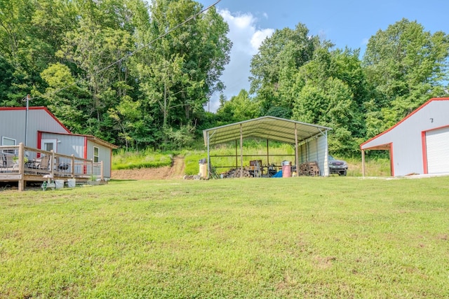 357 Providence Rd, Pulaski, TN 38478 - view of green lawn with a wooden deck, a detached carport, a garage, and an outdoor structure