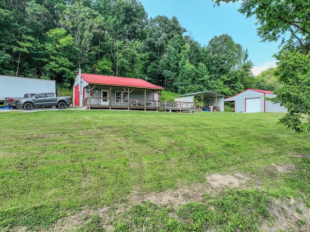 357 Providence Rd, Pulaski, TN 38478 - view of grassy yard featuring a garage, an outdoor structure, and a porch