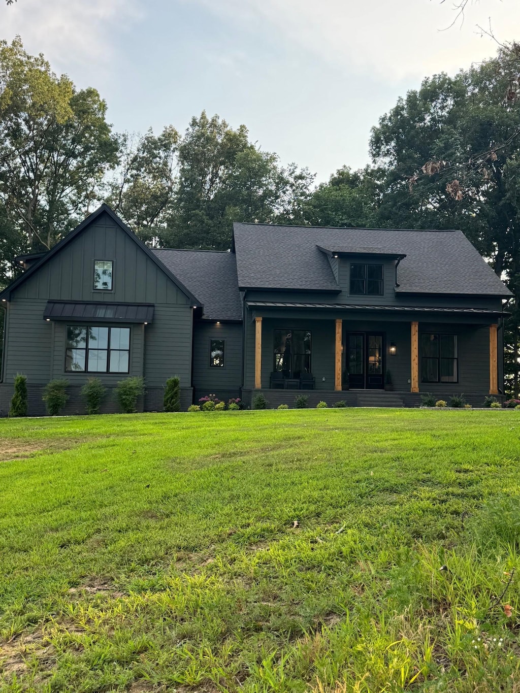 8921 Cedar Grove Rd, Cross Plains, TN 37049 - back of house featuring covered porch, a yard, board and batten siding, and roof with shingles