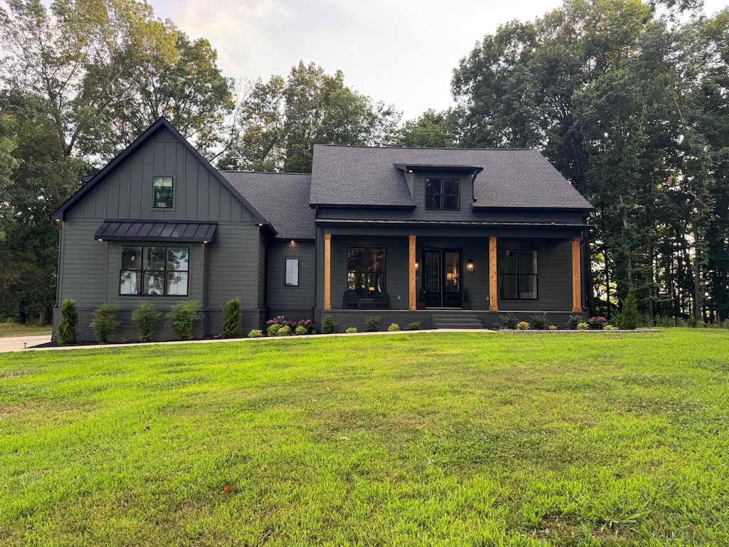 8921 Cedar Grove Rd, Cross Plains, TN 37049 - modern farmhouse featuring board and batten siding, a porch, a front yard, and a shingled roof