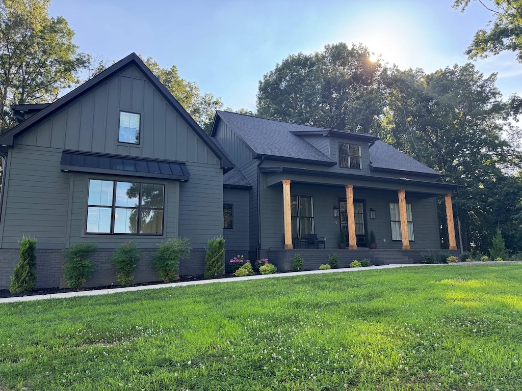 8921 Cedar Grove Rd, Cross Plains, TN 37049 - modern farmhouse style home with a porch, a front lawn, board and batten siding, and roof with shingles
