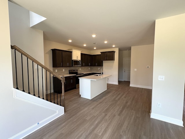 564 Twyla Dr, Lebanon, TN 37087 - kitchen featuring stainless steel appliances, recessed lighting, wood finished floors, tasteful backsplash, and a center island with sink