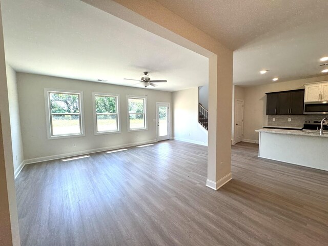 564 Twyla Dr, Lebanon, TN 37087 - unfurnished living room featuring stairs, wood finished floors, ceiling fan, and recessed lighting
