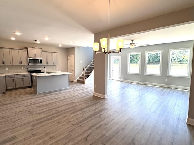 564 Twyla Dr, Lebanon, TN 37087 - kitchen featuring gray cabinets, open floor plan, stainless steel microwave, wood finished floors, and recessed lighting