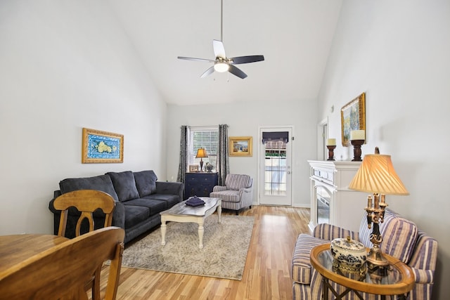 4858 Chelanie Cir, Murfreesboro, TN 37129 - living room with high vaulted ceiling, ceiling fan, light wood-type flooring, and a glass covered fireplace