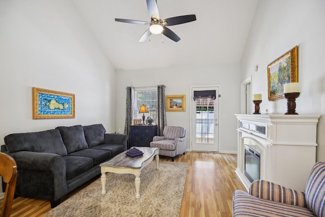 4858 Chelanie Cir, Murfreesboro, TN 37129 - living area featuring high vaulted ceiling, light wood-type flooring, a ceiling fan, and a glass covered fireplace