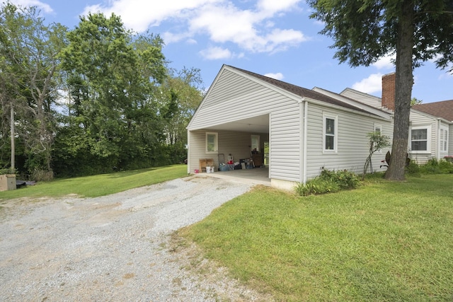 1509 5th Ave W, Springfield, TN 37172 - view of side of property featuring gravel driveway, an attached carport, a yard, and a chimney
