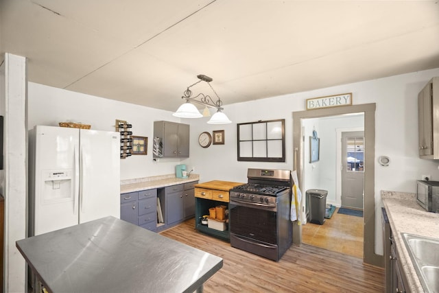 1509 5th Ave W, Springfield, TN 37172 - kitchen with appliances with stainless steel finishes, light wood-style flooring, gray cabinetry, and pendant lighting