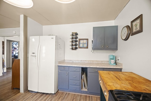 1509 5th Ave W, Springfield, TN 37172 - kitchen with white refrigerator with ice dispenser, gray cabinetry, light wood-style flooring, and range
