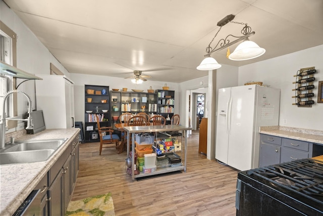 1509 5th Ave W, Springfield, TN 37172 - kitchen featuring white refrigerator with ice dispenser, light wood finished floors, gas stove, and gray cabinetry