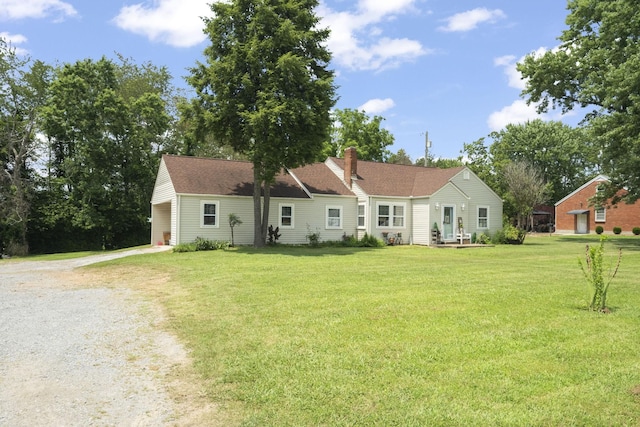 1509 5th Ave W, Springfield, TN 37172 - back of house with driveway, a lawn, a chimney, and a carport
