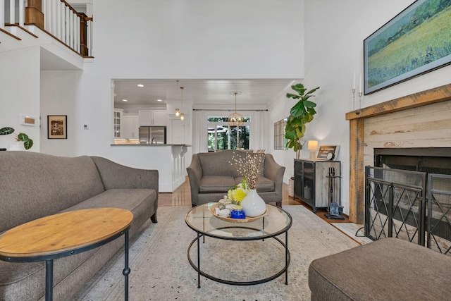 7106 Pepper Tree Cir, Fairview, TN 37062 - living room featuring light wood finished floors, a fireplace with flush hearth, recessed lighting, and a high ceiling