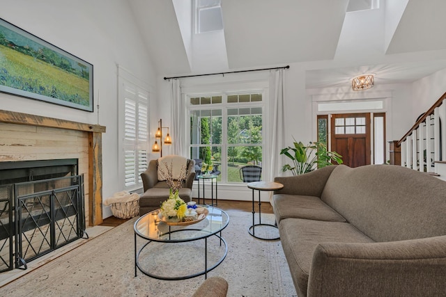 7106 Pepper Tree Cir, Fairview, TN 37062 - living area with lofted ceiling, a fireplace with flush hearth, stairway, wood finished floors, and a chandelier