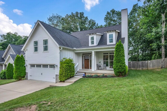 7106 Pepper Tree Cir, Fairview, TN 37062 - view of front facade with covered porch, concrete driveway, a chimney, an attached garage, and a shingled roof