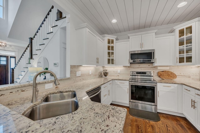 7106 Pepper Tree Cir, Fairview, TN 37062 - kitchen featuring stainless steel appliances, recessed lighting, white cabinets, dark wood finished floors, and light stone counters