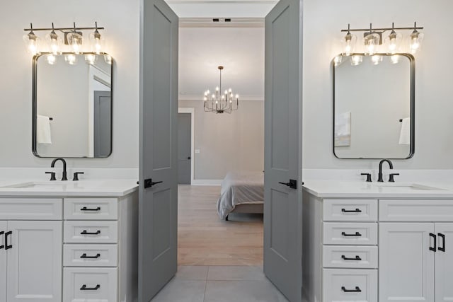 9409 Clovercroft Rd, Franklin, TN 37067 - bathroom featuring two vanities, a chandelier, ornamental molding, tile patterned flooring, and ensuite bath