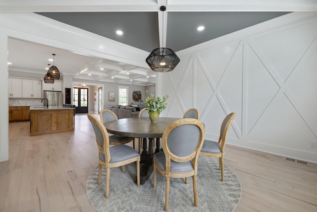 9409 Clovercroft Rd, Franklin, TN 37067 - dining space with a decorative wall, light wood finished floors, recessed lighting, beam ceiling, and coffered ceiling