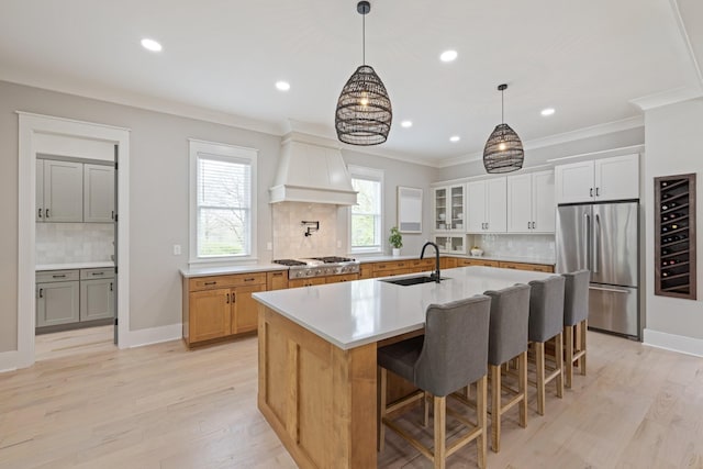 9409 Clovercroft Rd, Franklin, TN 37067 - kitchen featuring appliances with stainless steel finishes, custom range hood, decorative backsplash, recessed lighting, and light wood-style floors